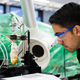 A graduate student prints fluorescein crystals onto a cooled glass plate using organic vapor jet printing. Image: University of Michigan
